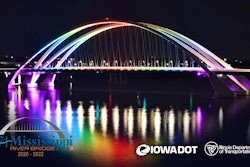 The dual-arch I-74 Mississippi River Bridge lit up at night