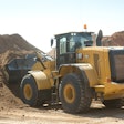Cat wheel loader digging into dirt pile