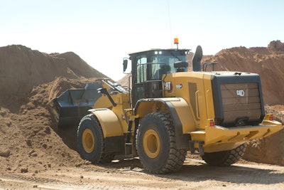 Cat wheel loader digging into dirt pile