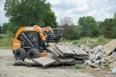 Case SV340B skid steer unloading concrete slabs from forks