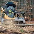 FAE BL4/SSL forestry mulcher attachment on Caterpillar compact track loader mulching felled tree in woods