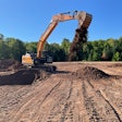 Case E Series Excavator dumping a bucket of dirt