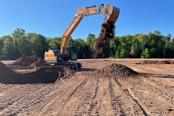 Case E Series Excavator dumping a bucket of dirt