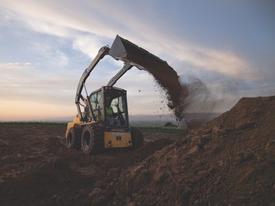 New Holland L328 skid steer dumps dirt from bucket onto dirt pile