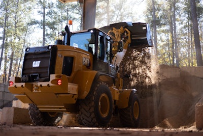 Cat small wheel loader getting dirt from pile