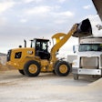 Cat 926 wheel loader dumping bucket into truck