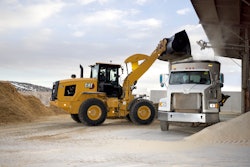 Cat 926 wheel loader dumping bucket into truck