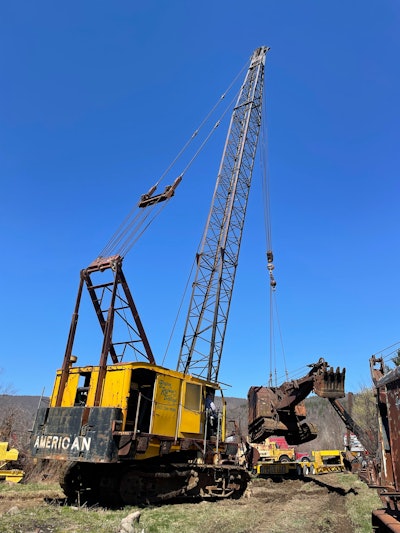American 975 crawler crane hoisting a rusted late-1930s Link-Belt crane