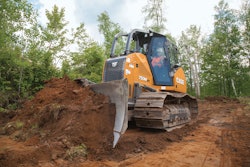Case 750M bulldozer pushing dirt in the woods
