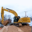 Cat 336 Hydraulic Crawler Excavator digging in a neighborhood