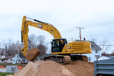 Cat 336 Hydraulic Crawler Excavator digging in a neighborhood