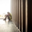 Construction worker sitting on the floor in despair