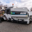 Leeboy 8520C E-Paver electric commercial class paver all white on blacktop trees background