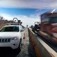 Jeep SUV with automated speed camera beside busy highway work zone