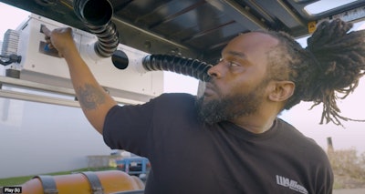 operator touches control on Cabin Cool M100 air conditioner for open cab equipment