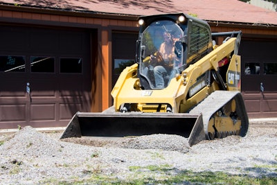 Taylor Clingerman runs Cat compact track loader pushing gravel