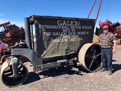 Robert Dahs in red white pokodot cap beside his 1930 Galion International Motor Roller with side canopy down