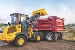John Deere 244 P-Tier compact wheel loader dumping load.