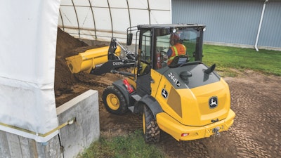 John Deere 244 P-Tier wheel loader digging into dirt pile