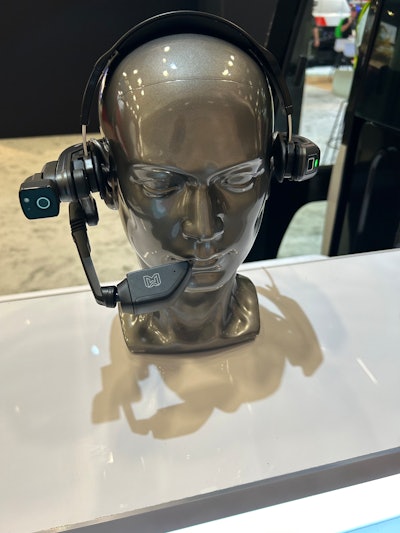 bald silver dummy head with Realwear headset at Link-Belt booth at ConExpo 2023