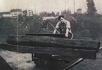 Brochure photograph of a man using the Mead Mighty Mouse to move logs