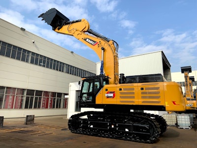 Sany SY750H large excavator raising bucket over building