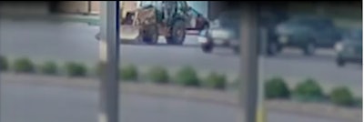 surveillance video screenshot of video posted on Williamson County Sheriff's Office Facebook page of man driving stolen backhoe to airport