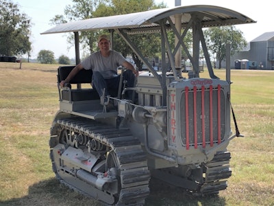 Tom pfeiffer sitting in restored 1929 Caterpillar Thirty crawler tractor