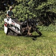 Bobcat MT100 mini track loader carrying logs