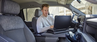 2023 Ford Super Duty Workstation man in driver seat working on laptop