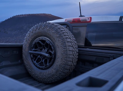 The beefy 35-inch Goodyear Wrangler spare tire is too big to be mounted under the truck so it's mounted in the bed instead.