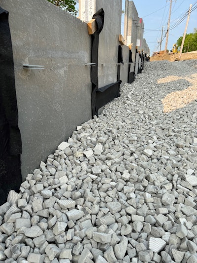 AeroAggregate's ultra-lightweight foamed glass aggregate beside concrete retaining wall