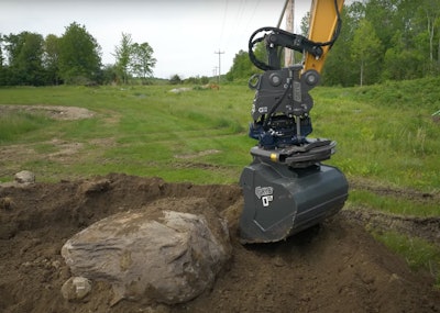 GRYB GTR15 tiltrotator on excavator arm digging around large rock