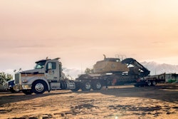 Semi hauling a John Deere Excavator