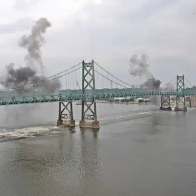 smoke rises after the old eastbound I-74 bridge over the Mississippi River between Illinois and Iowa is exploded