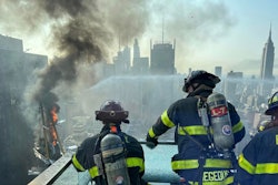 Firefighters work to put out a fire after a crane collapse in new york city