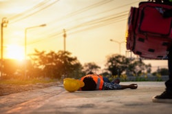 stock image worker lying on ground heat stroke first aid training