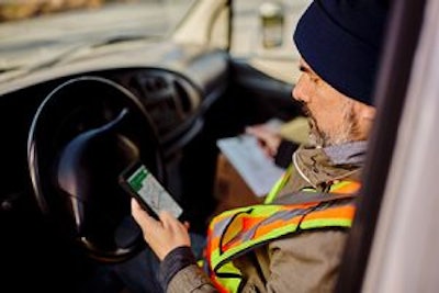 Man in safety vest sitting in a vehicle using smart phone with a DuraForce PRO 3 case