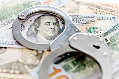 handcuffs on $100 bills