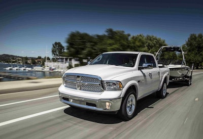 white 2016 Ram 1500 Laramie EcoDiesel towing boat