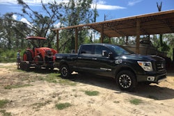 2019 Titan XD diesel hitched to trailer carrying tractor