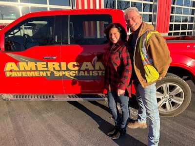 Colleen and Bill Stanley stand beside red American Pavement Specialist pickup truck