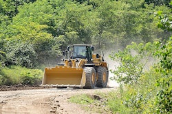 Cat 988 GC wheel loader traveling on dirt road