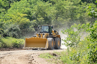 Cat 988 GC wheel loader traveling on dirt road