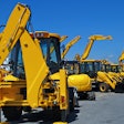 line of construction equipment at auction