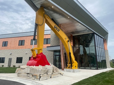 Veit excavator boom and arm at the entrance to the office