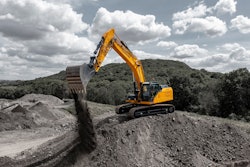 Liugong 936F excavator atop quarry hill releasing dirt