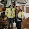 Missy & Trevor Scherber owners of T Scherber Demolition & Excavating on jobsite in front of excavator