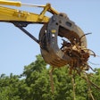 Werk-Brau Box-Style Grapple on end of excavator picking up branches