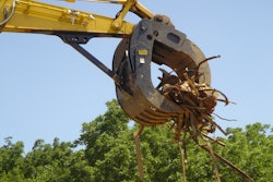 Werk-Brau Box-Style Grapple on end of excavator picking up branches